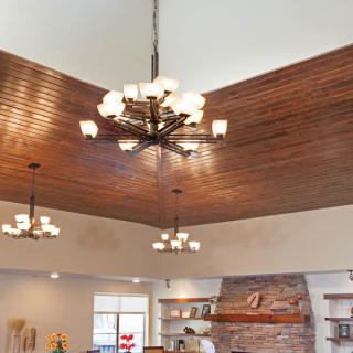 Elegant interior featuring multiple chandeliers and a wooden ceiling.