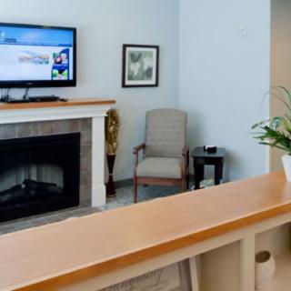 A cozy living room featuring a fireplace, TV, and comfortable seating.