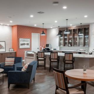 A modern living space with a bar area and comfortable seating.