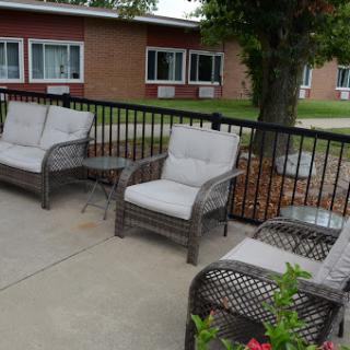 A cozy outdoor seating area featuring comfortable chairs and a small table, perfect for relaxation.