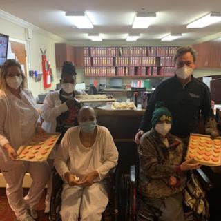Healthcare staff sharing treats with patients in a hospital setting.