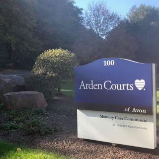 A sign for Arden Courts of Avon in a landscaped outdoor setting.