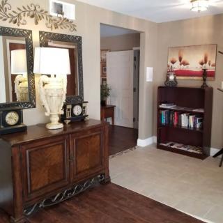 A cozy interior featuring elegant furniture, mirrors, and decorative elements.