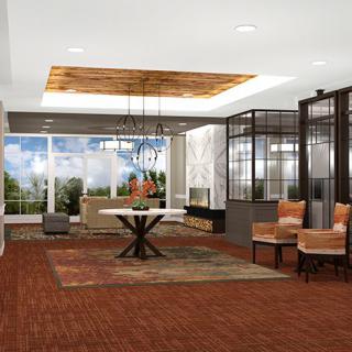 A modern living room with stylish furniture, wooden flooring, and a large window offering a garden view.