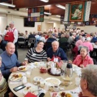 A group of people enjoying a meal together at a community event.