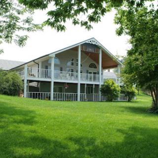 A modern house set amidst a lush green lawn.