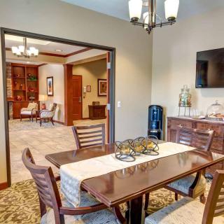 A modern dining room with a wooden table, chairs, and decorative elements.