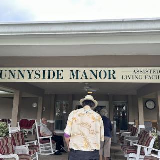 A resident walking towards Sunnyside Manor, an assisted living facility.