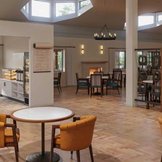 A cozy and spacious dining area with modern furniture and ambient lighting.