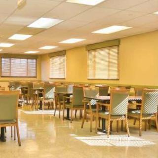 An empty dining room with neatly arranged tables and chairs.