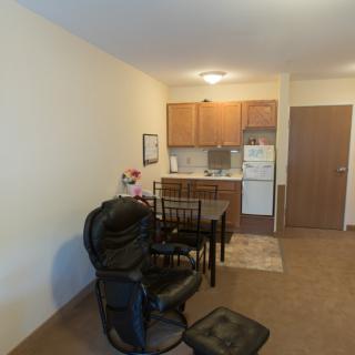 A cozy apartment interior with a small kitchen and dining area.
