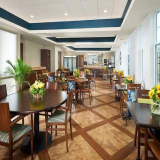 A spacious and inviting dining area featuring modern decor and natural light.