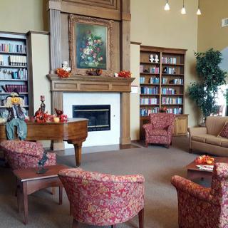Cozy living room with a fireplace, bookshelves, and comfortable seating.