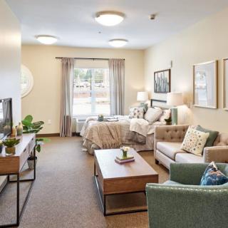 A cozy and modern apartment interior with a combined living room and bedroom area, featuring stylish decor and furniture.
