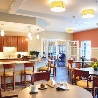 A cozy dining and kitchen area with wooden furniture and warm lighting.