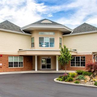 Front view of a residential building with landscaped entrance and driveway.