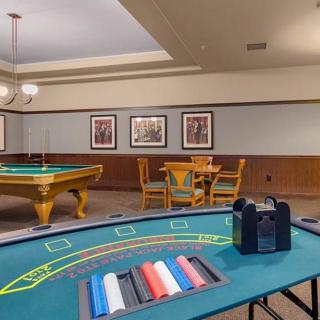 A cozy game room featuring a casino table and pool table for recreation.