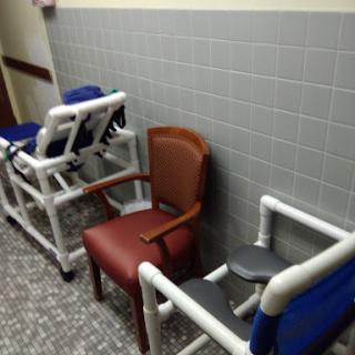 A row of various chairs in a healthcare setting.