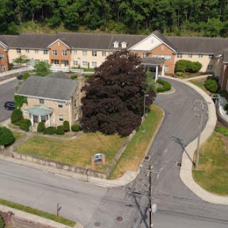 An aerial view of a residential area showcasing buildings and surrounding greenery.