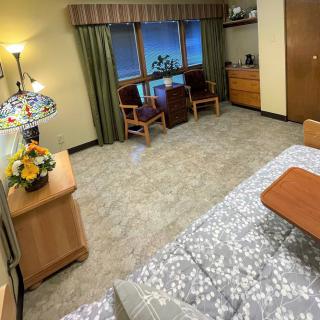 A cozy bedroom with elegant furnishings and floral decorations.