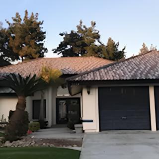 A single-story residential house with a tiled roof and attached garage.