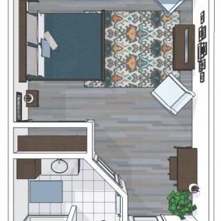 A floor plan of a bedroom featuring a bed, desk, chair, and bathroom.