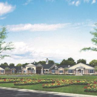 A scenic view of a group of buildings set against a clear blue sky, surrounded by lush landscaping.