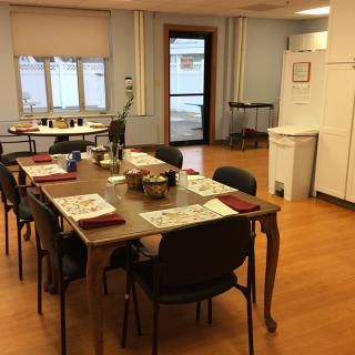 A dining room with a neatly set table and chairs, ready for a meal.