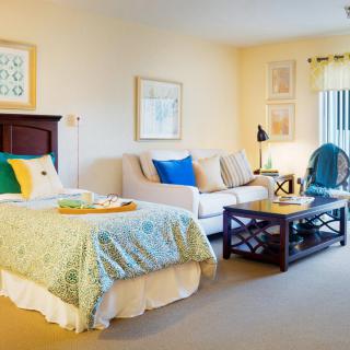 A cozy bedroom with a comfortable bed and a stylish seating area.