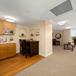 A cozy apartment interior with a kitchenette, dining area, and living room.