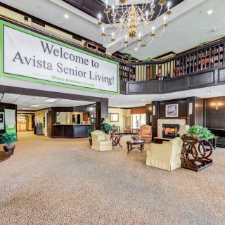 A welcoming lobby area of Avista Senior Living featuring comfortable seating and a fireplace.