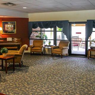 A cozy lobby area with comfortable seating and large windows.