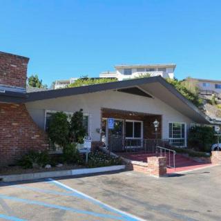 A suburban building with a parking lot and entrance.