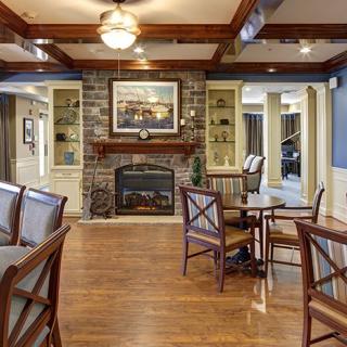 A cozy living room with a stone fireplace and elegant furniture.