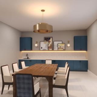A modern dining room with a wooden table and blue cabinetry, featuring contemporary lighting and decor.