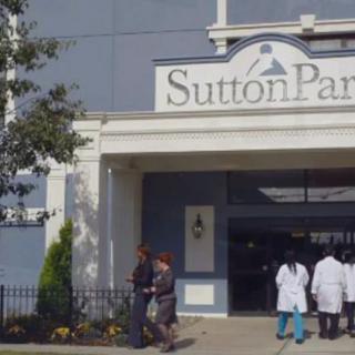 Entrance to Sutton Park with people entering and exiting.