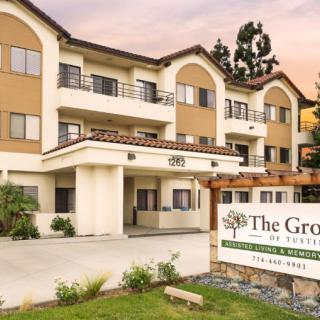 Exterior view of a residential apartment building with a sign in front.