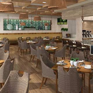 A modern restaurant interior with neatly arranged tables and chairs, featuring stylish decor.