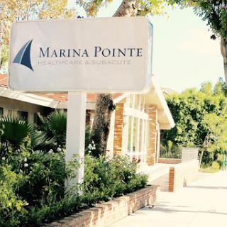 A sunny day view of the Marina Pointe sign, welcoming visitors to the community.