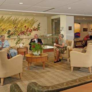 A group of seniors relaxing in a comfortable lounge area.