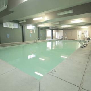 An empty indoor swimming pool with a calm and serene atmosphere.