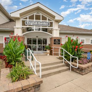 A welcoming community center entrance surrounded by vibrant landscaping.