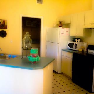 A cozy kitchen with essential appliances and a countertop in a home setting.