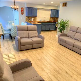 A modern open-plan living area with comfortable seating and a stylish kitchen.