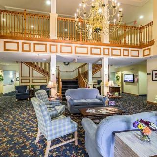 Elegant hotel lobby with a chandelier and comfortable seating.
