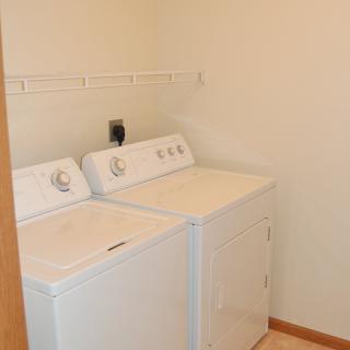 A small laundry room with a washer and dryer set.