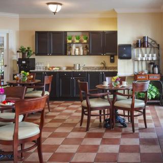 A cozy dining area with dark cabinets and wooden furniture.