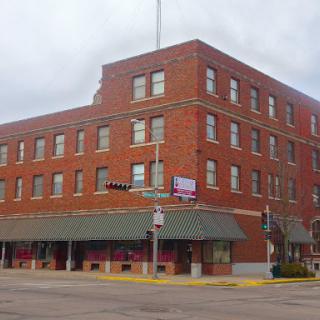 A historic brick building with a storefront located in a small town.