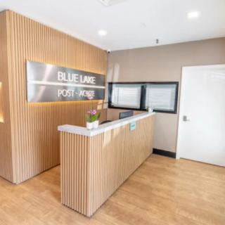 A modern reception area with a wooden desk and sleek design.
