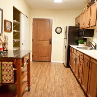 A cozy kitchen with wooden cabinets and a central island.